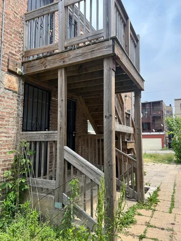 a view of small house with wooden floor and fence