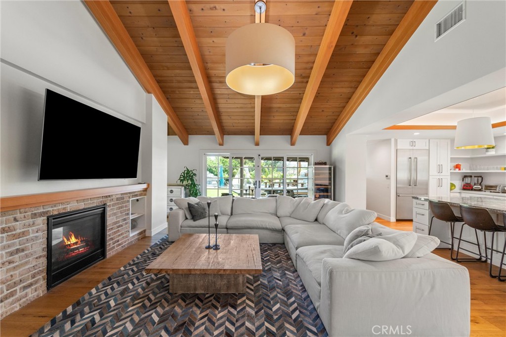 7337 La Soldadera Rancho Santa Fe, CA 92067 - Photo 14 of 60 a living room with furniture a flat screen tv and a fireplace