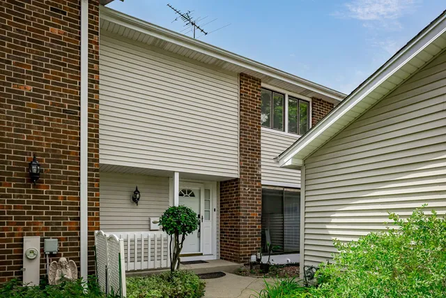 a front view of a house with plants