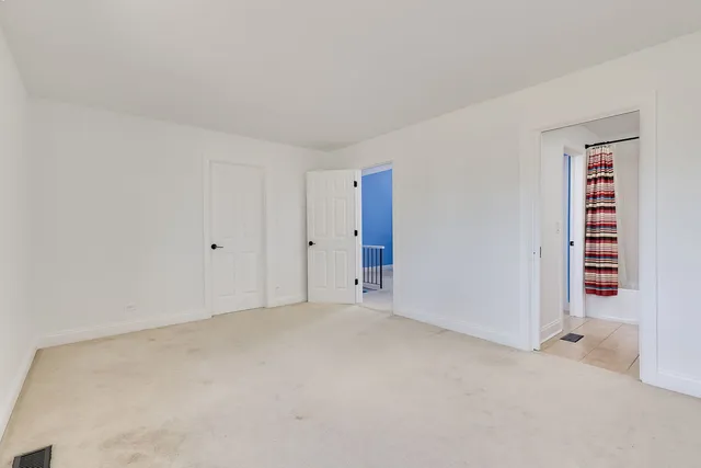 a view of an empty room and fire place