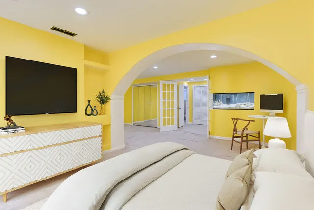 a spacious bedroom with a bed and couch