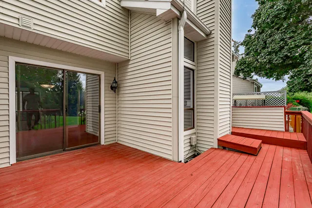 a view of a deck with wooden floor and floor to ceiling window