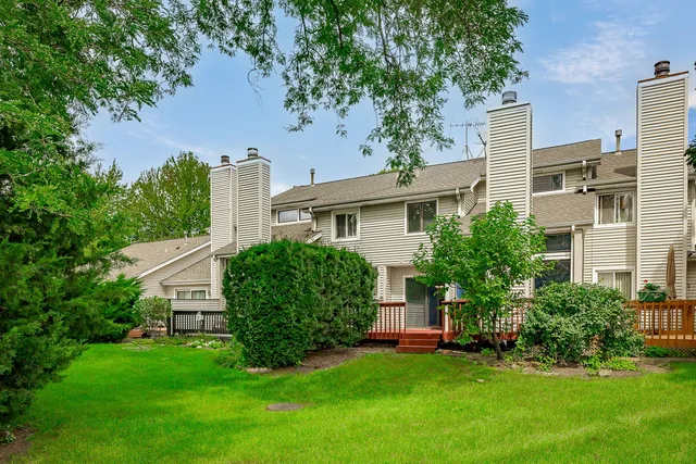 a view of a house with a yard and a garden