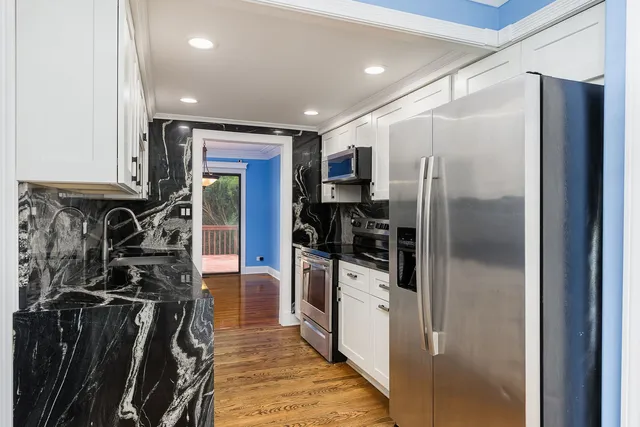 a kitchen with a refrigerator and a sink