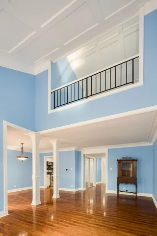 a view of a livingroom with wooden floor and a bathroom