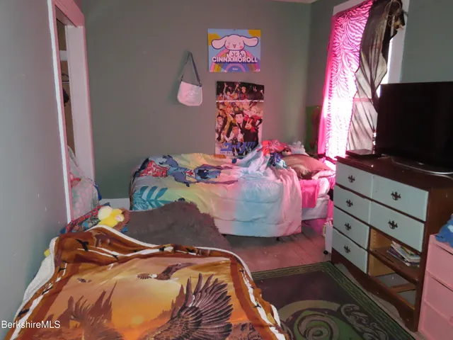 a bedroom with a bed and a table