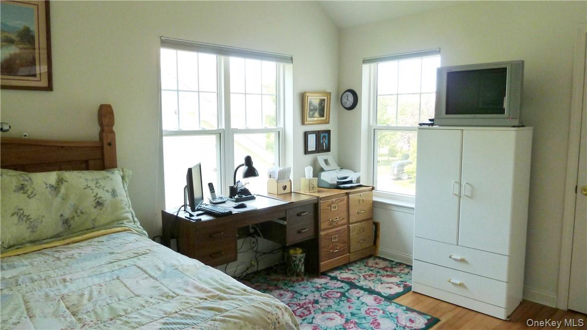 107 Winding Ridge Road, Unit 107 White Plains, NY 10603 - Photo 18 of 30 a bedroom with a bed and a flat screen tv