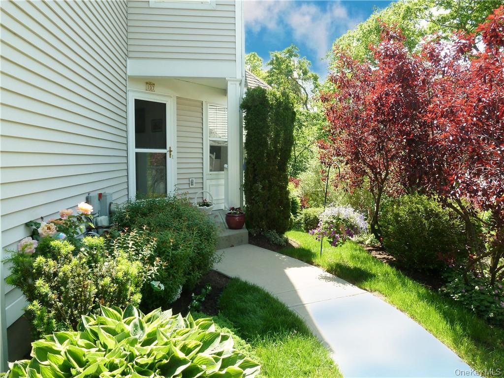 107 Winding Ridge Road, Unit 107 White Plains, NY 10603 - Photo 2 of 30 a front view of a house with a yard