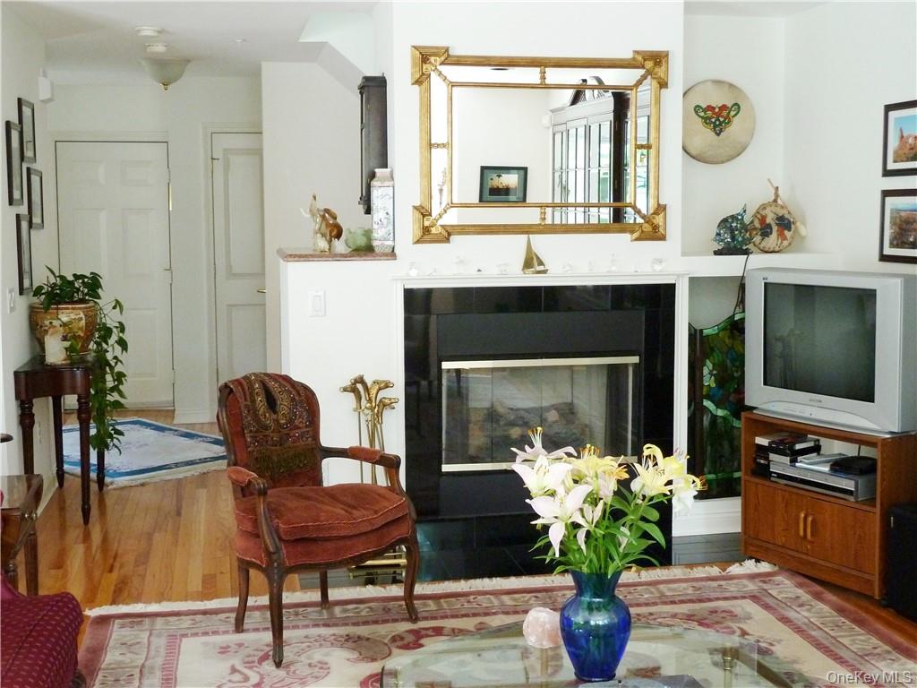 107 Winding Ridge Road, Unit 107 White Plains, NY 10603 - Photo 4 of 30 a living room with furniture and a fireplace