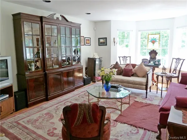 a living room with fireplace furniture and a rug