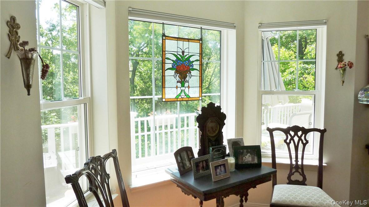 107 Winding Ridge Road, Unit 107 White Plains, NY 10603 - Photo 6 of 30 a living room with furniture and a floor to ceiling windows