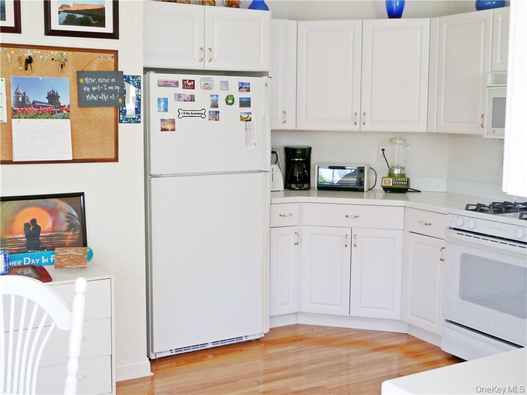 107 Winding Ridge Road, Unit 107 White Plains, NY 10603 - Photo 9 of 30 a white refrigerator freezer sitting inside of a kitchen