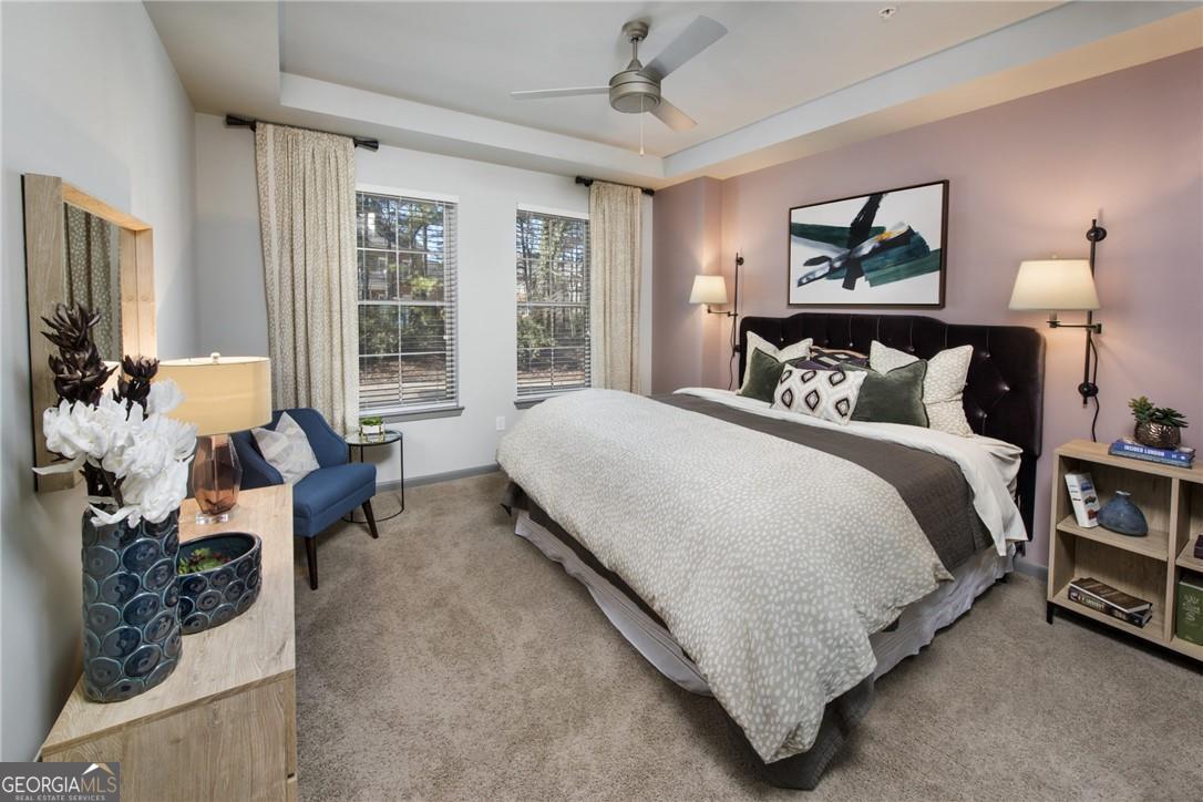 6919 Peachtree Road, Unit 545 Atlanta, GA 30328 - Photo 11 of 38 Bedroom featuring a raised ceiling, light carpet, and ceiling fan