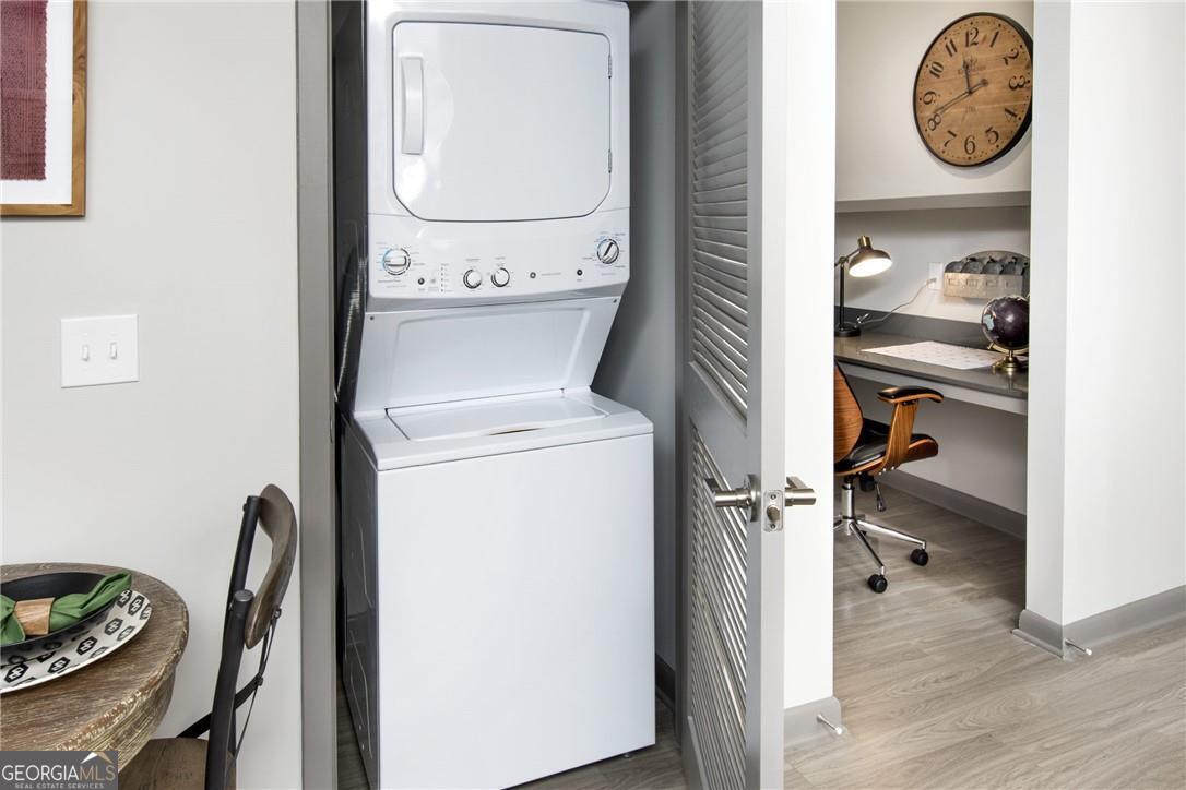 6919 Peachtree Road, Unit 545 Atlanta, GA 30328 - Photo 8 of 38 Clothes washing area with light wood-type flooring and stacked washing machine and dryer