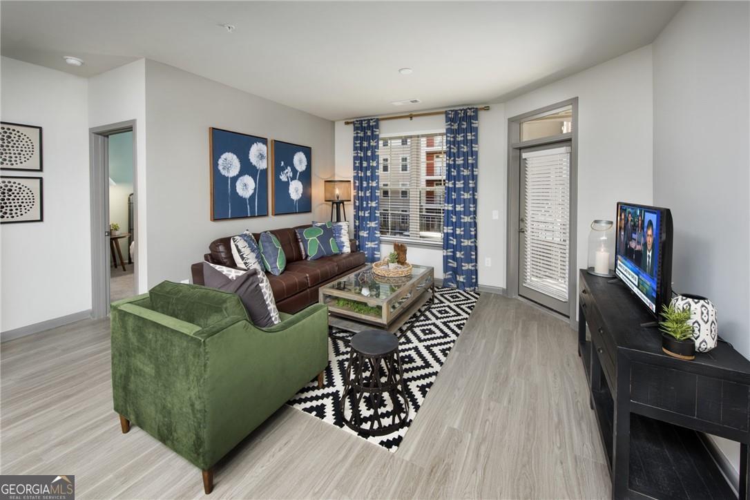 6919 Peachtree Road, Unit 545 Atlanta, GA 30328 - Photo 10 of 38 Living room featuring light wood-type flooring