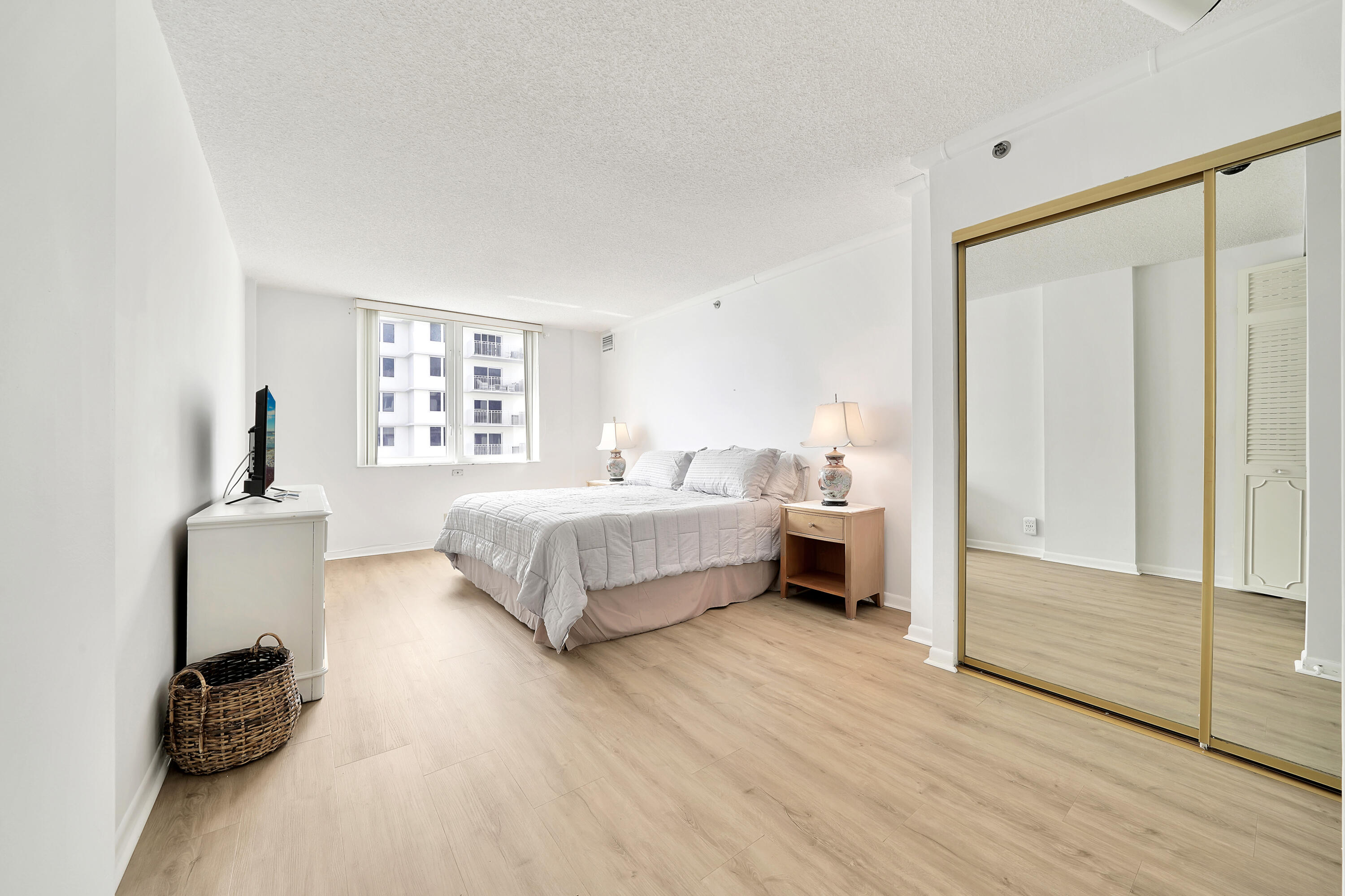 3215 South Ocean Boulevard, Unit 707 Highland Beach, FL 33487 - Photo 12 of 37 a spacious bedroom with a bed and a window