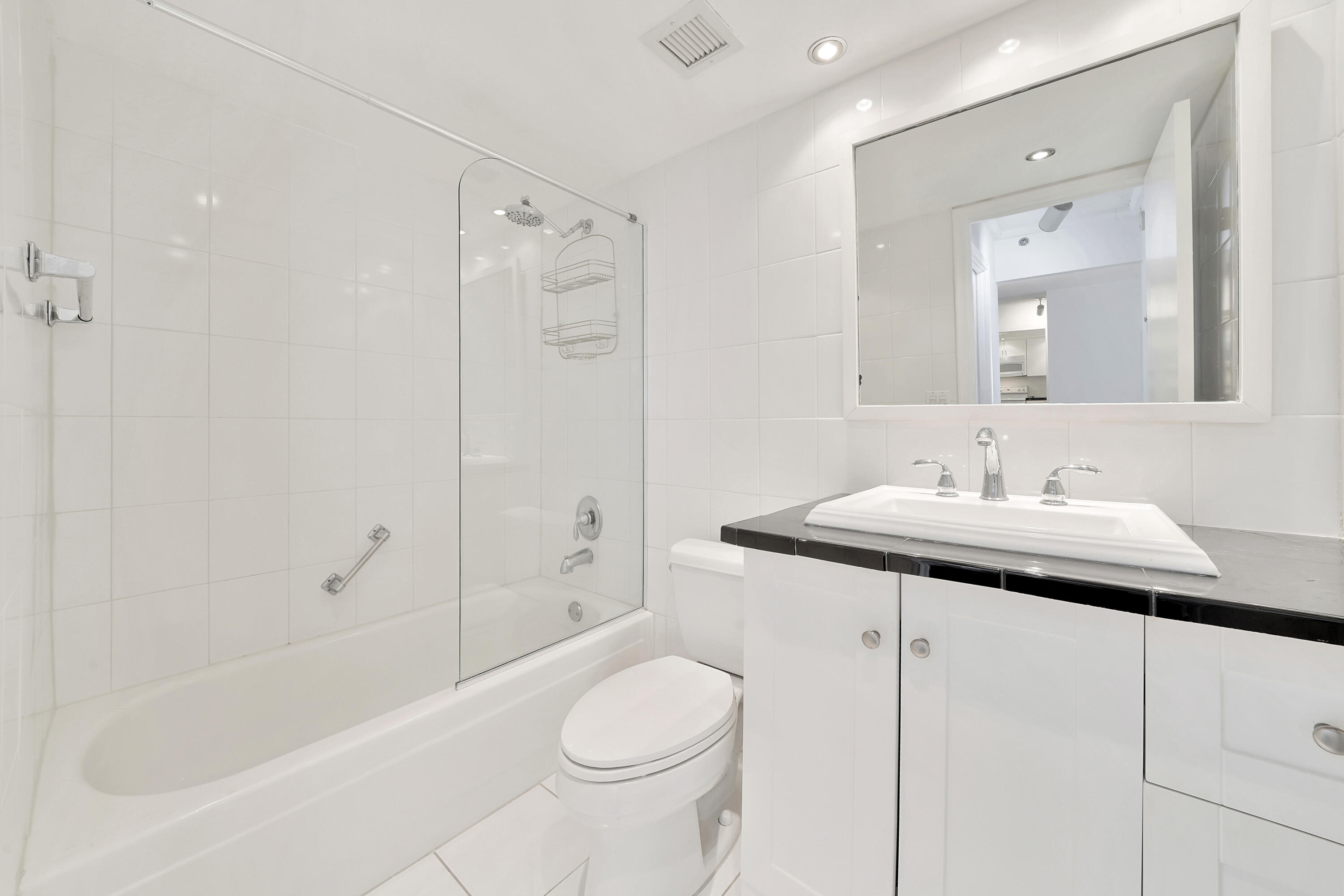 3215 South Ocean Boulevard, Unit 707 Highland Beach, FL 33487 - Photo 16 of 37 a bathroom with a sink toilet and shower