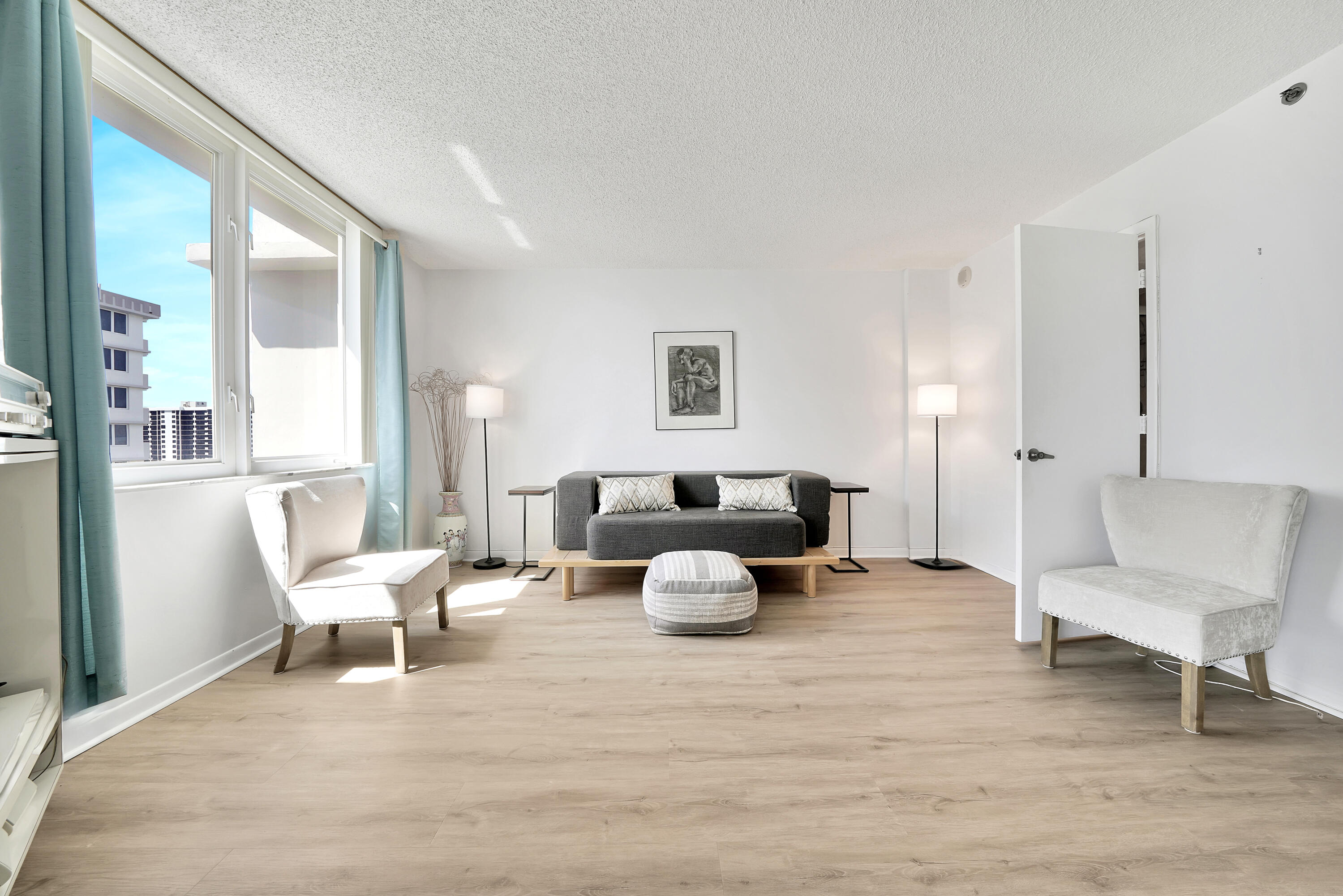 3215 South Ocean Boulevard, Unit 707 Highland Beach, FL 33487 - Photo 17 of 37 a living room with furniture and a lamp