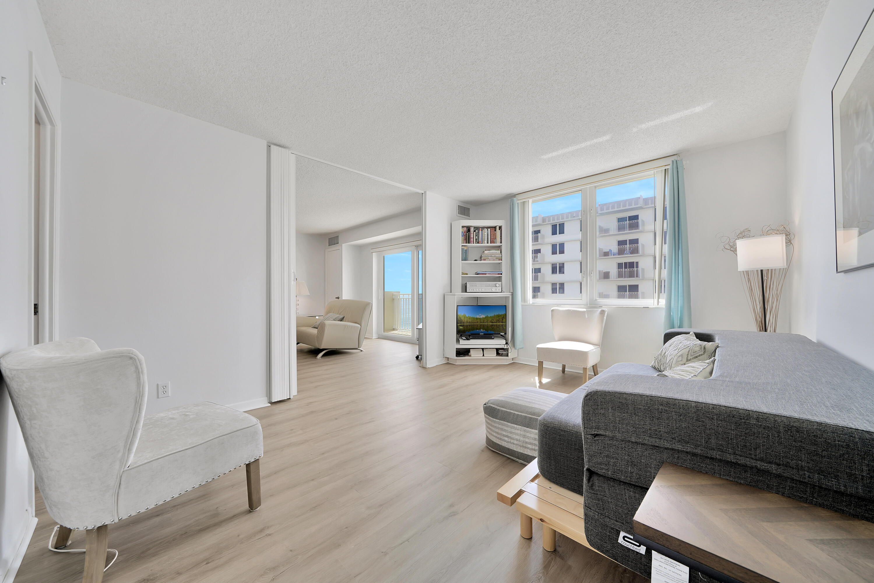 3215 South Ocean Boulevard, Unit 707 Highland Beach, FL 33487 - Photo 19 of 37 a bedroom with furniture and a wooden floor