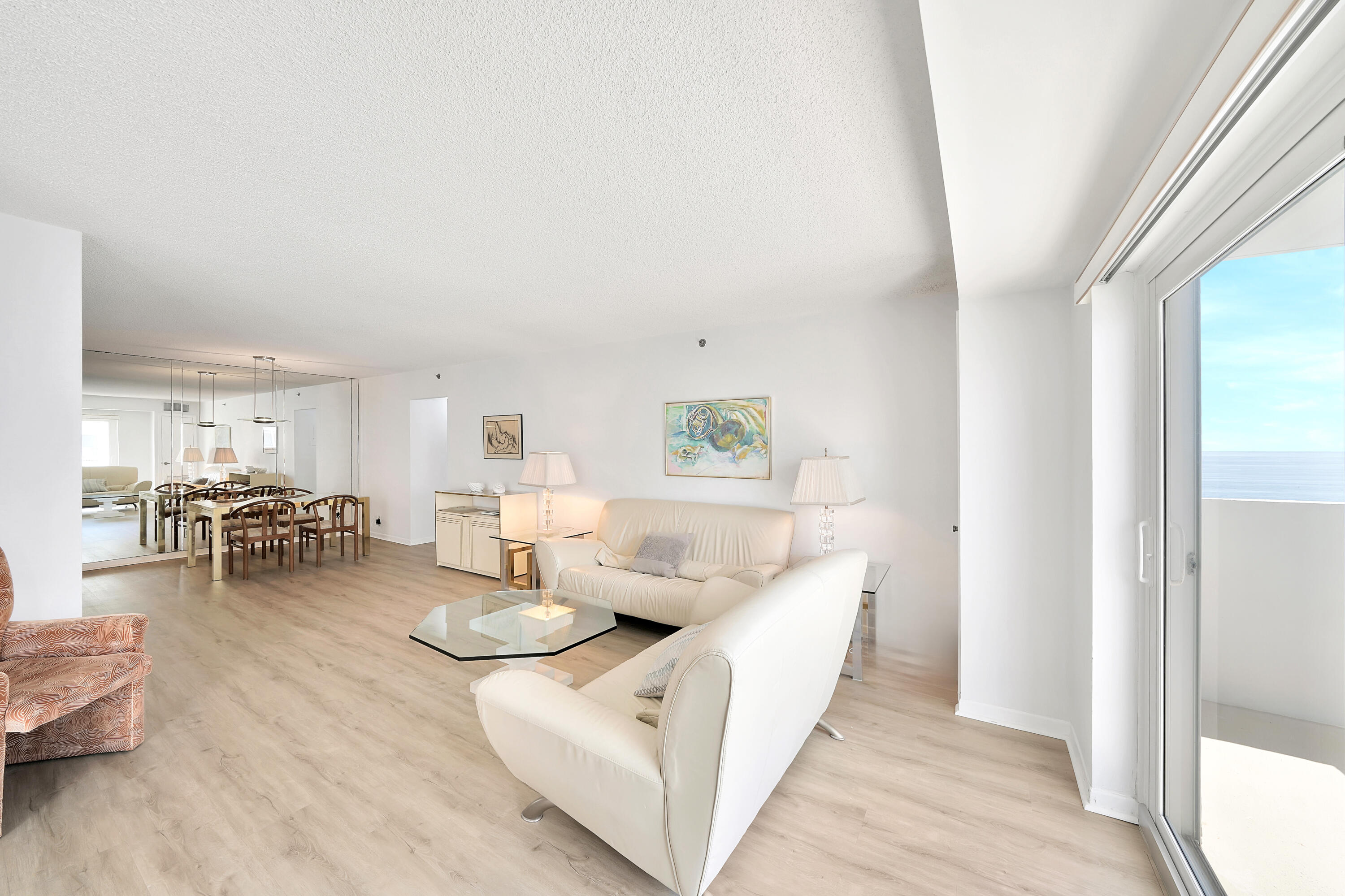 3215 South Ocean Boulevard, Unit 707 Highland Beach, FL 33487 - Photo 3 of 37 a living room with furniture and a table