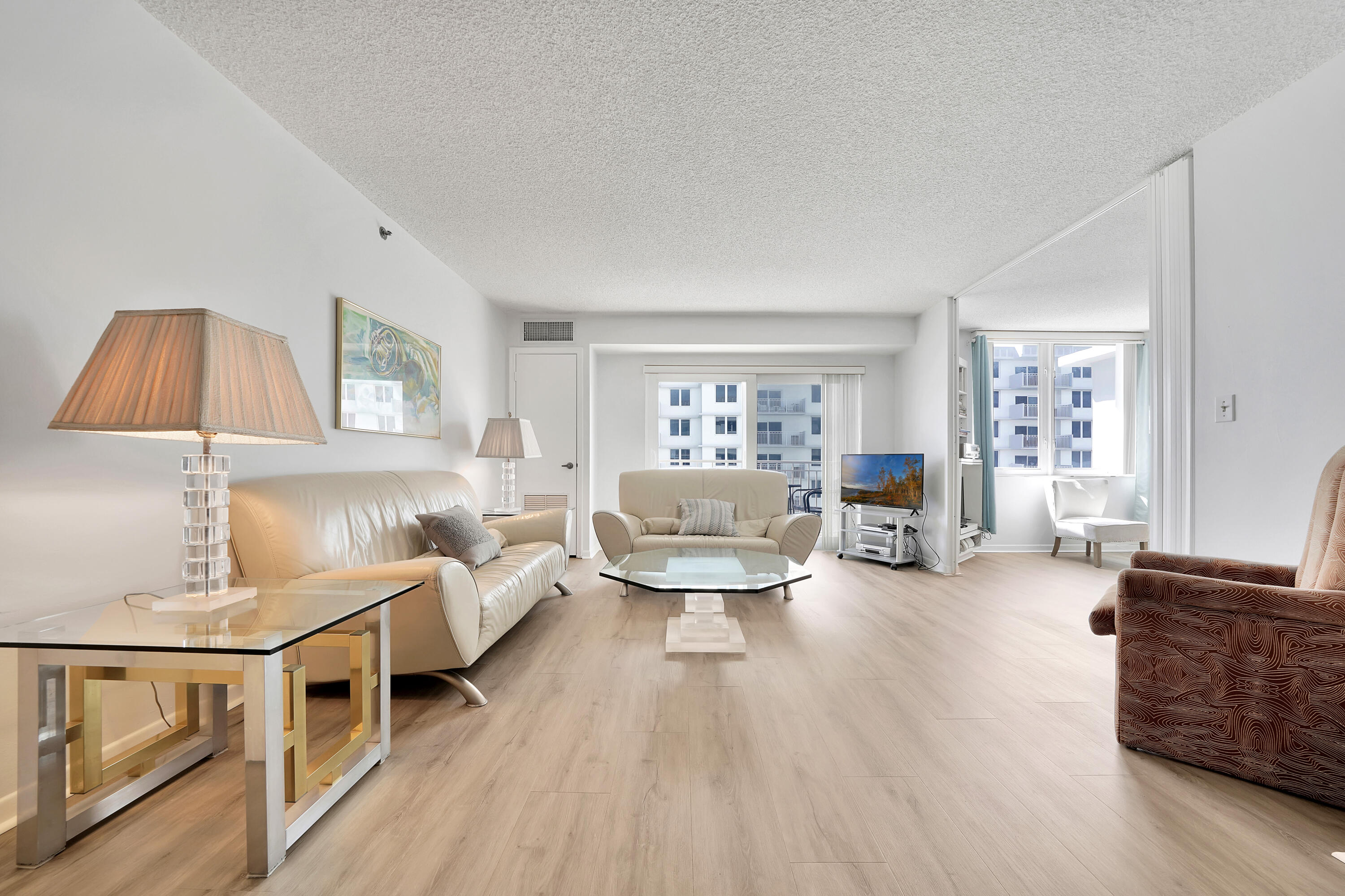 3215 South Ocean Boulevard, Unit 707 Highland Beach, FL 33487 - Photo 4 of 37 a living room with furniture and a wooden floor
