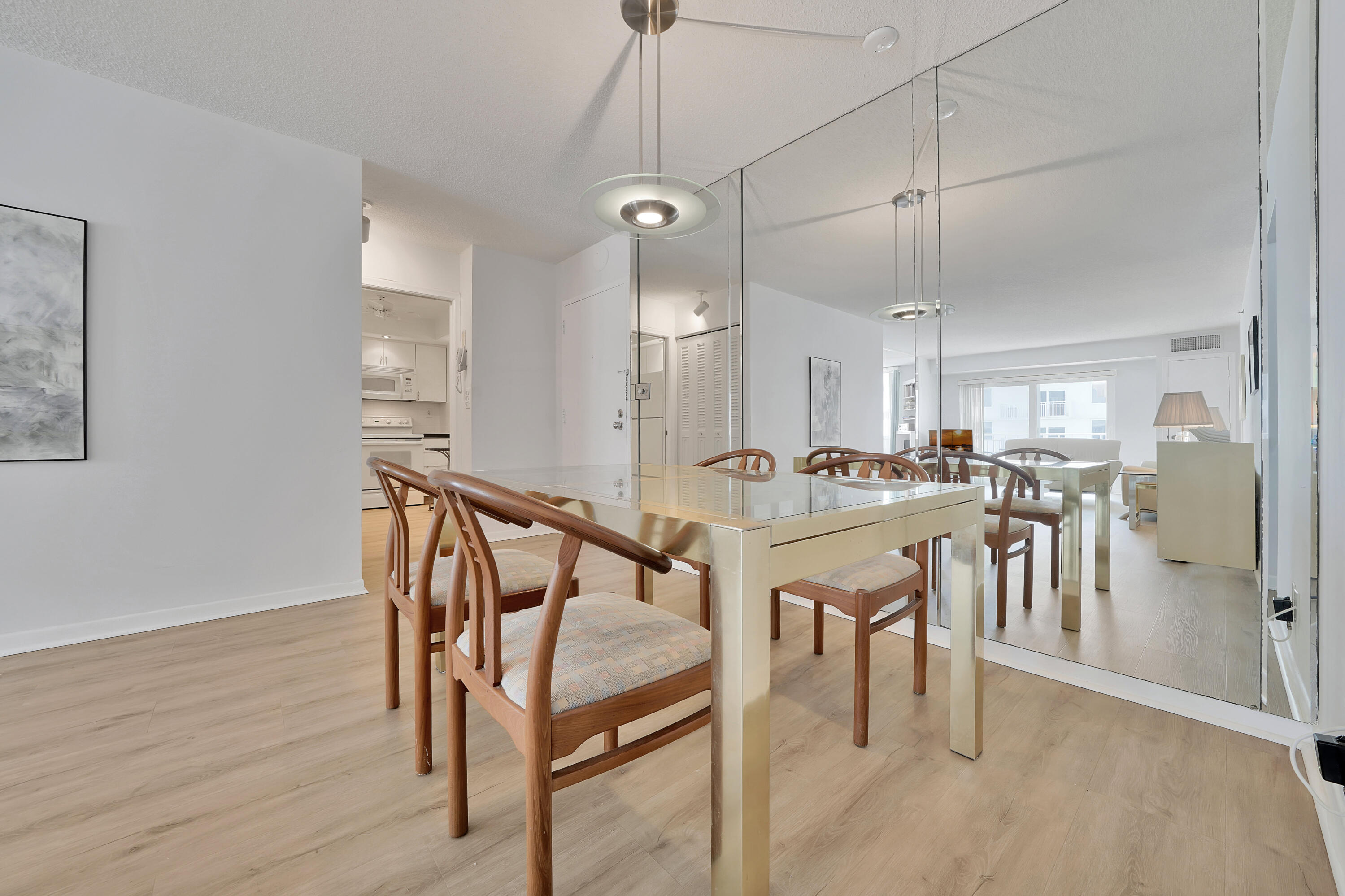 3215 South Ocean Boulevard, Unit 707 Highland Beach, FL 33487 - Photo 8 of 37 a view of a dining room with furniture and wooden floor