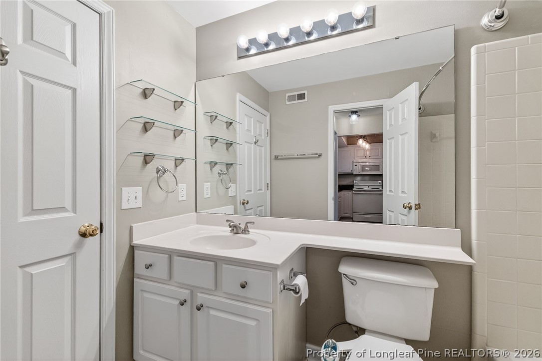 1221 Westview Lane, Unit 301 Raleigh, NC 27605 - Photo 22 of 32 a bathroom with a sink double vanity and a mirror