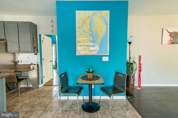 a dining room with furniture and a window