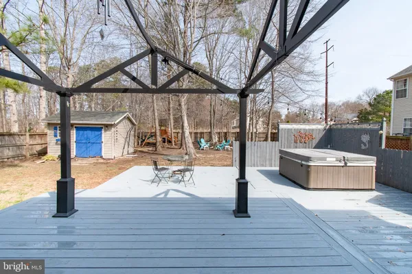 a patio view with couches and a fire pit