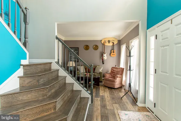 a view of entryway and hall with wooden floor