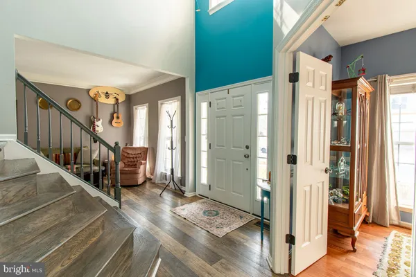 a view of entryway with wooden floor and stairs