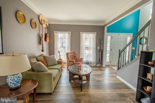 a living room with furniture and a book shelf