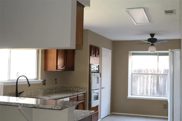 a kitchen with sink refrigerator and window