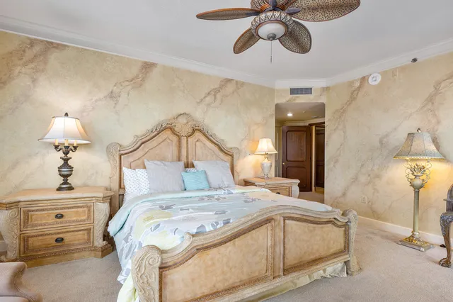 a bedroom with a bed and a chandelier