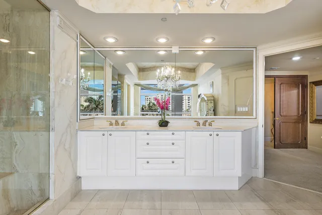 a dining room with furniture water view and a floor to ceiling window