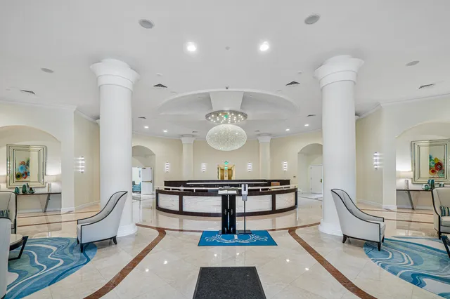 a group of palm trees sitting in front of a building