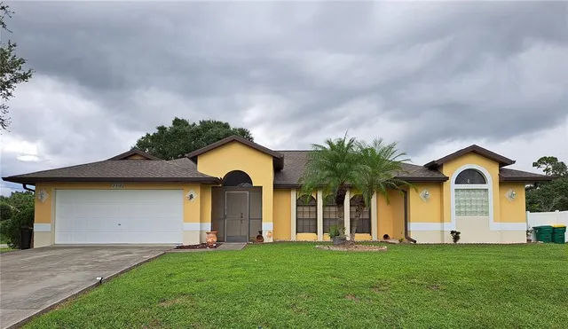 a front view of a house with a yard and garage