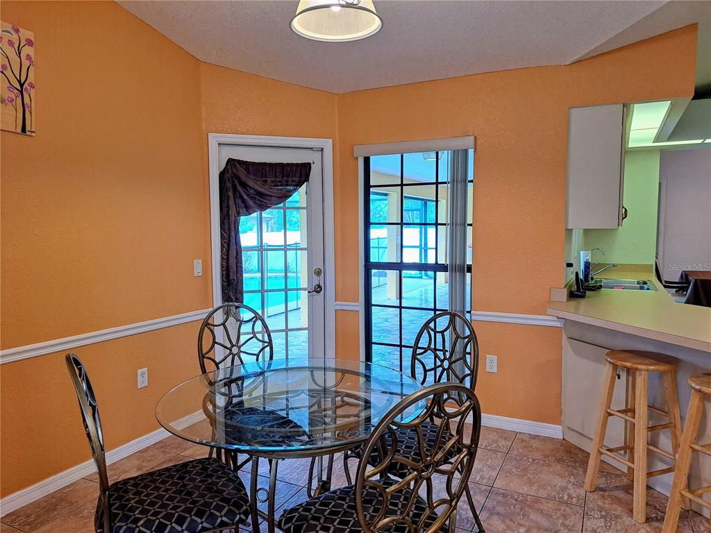 23180 Avacado Avenue Punta Gorda, FL 33980 - Photo 11 of 30 a dining room with furniture and window