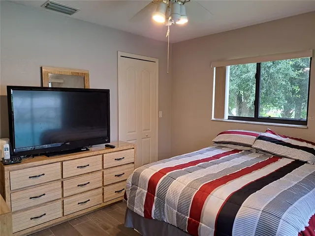 a bed sitting in a bedroom next to a window