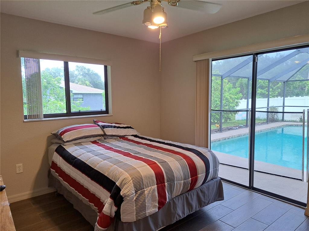 23180 Avacado Avenue Punta Gorda, FL 33980 - Photo 17 of 30 a bed sitting in a bedroom next to a window