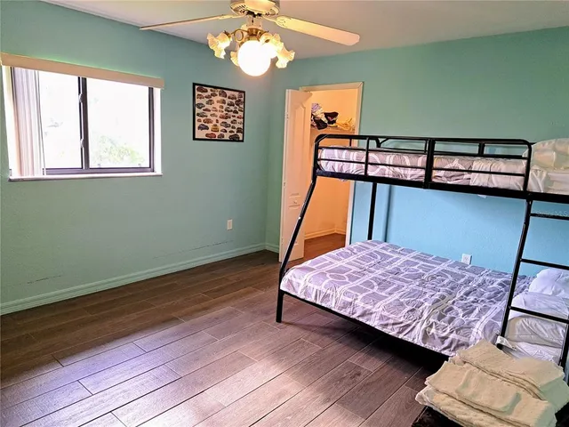 a bedroom with a bed and dresser with mirror