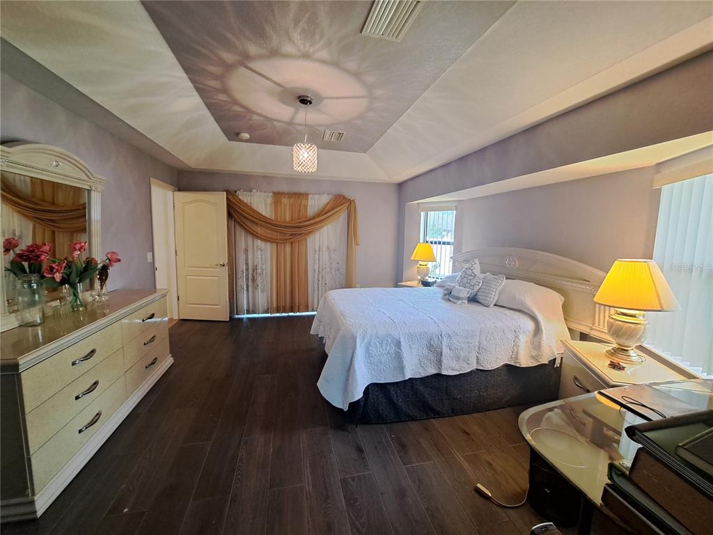 23180 Avacado Avenue Punta Gorda, FL 33980 - Photo 21 of 30 a bedroom with a bed and dresser with mirror