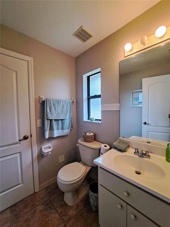 23180 Avacado Avenue Punta Gorda, FL 33980 - Photo 25 of 30 a bathroom with a toilet sink and mirror