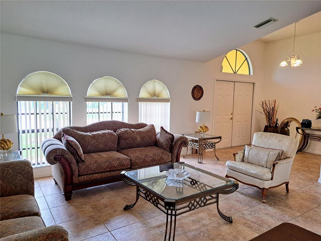 23180 Avacado Avenue Punta Gorda, FL 33980 - Photo 5 of 30 a living room with furniture a lamp and a large window
