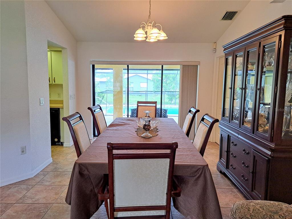 23180 Avacado Avenue Punta Gorda, FL 33980 - Photo 7 of 30 a view of a dining room with furniture window and outside view