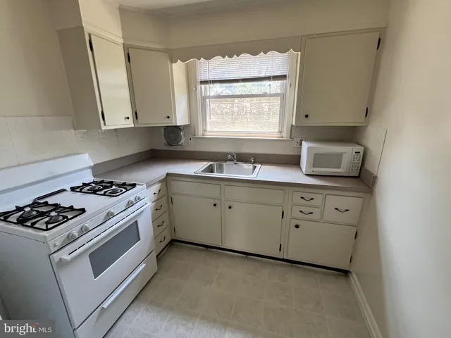 a kitchen with a refrigerator sink and stove