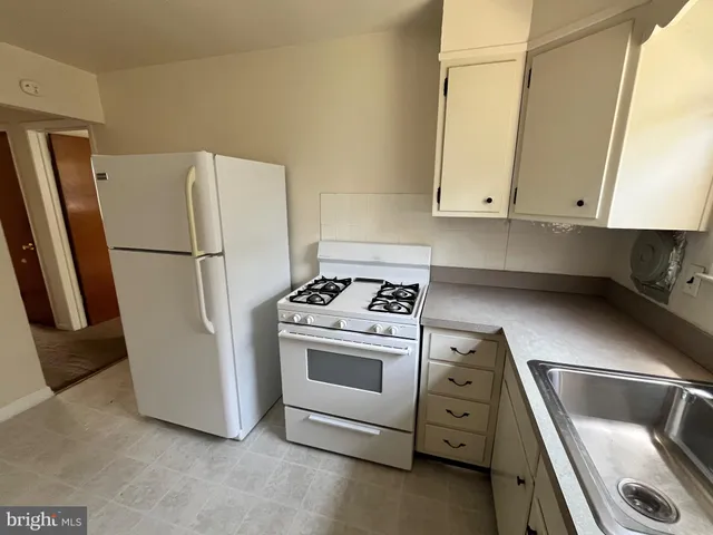 a view of a hallway with closet and wooden floor