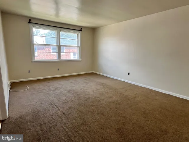 an empty room with a fireplace