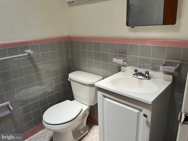 a bathroom with a sink a toilet and a mirror