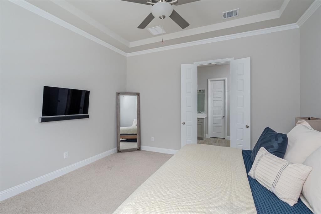 1412 Bear Path Way Gunter, TX 75058 - Photo 12 of 37 a bedroom with a bed and a flat screen tv